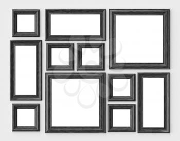 Black wood blank photo or picture frames on white wall with shadows with copy-space, decorative wooden picture frames template set, art frame mock-up 3D illustration