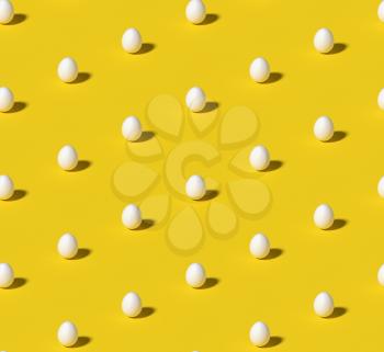 White eggs on bright yellow seamless isometric minimalistic background. Minimal food concept still life pattern. 3D illustration