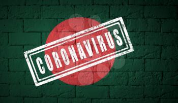 Flag of the Bangladesh with original proportions. stamped of Coronavirus. brick wall texture. Corona virus concept. On the verge of a COVID-19 or 2019-nCoV Pandemic.