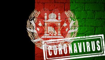 Flag of Afghanistan with original proportions, stamped of Coronavirus. brick wall texture. Corona virus concept. On the verge of a COVID-19 or 2019-nCoV Pandemic.