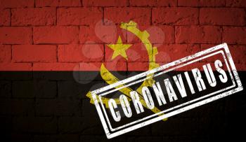 Flag of the Angola on brick wall texture. stamped of Coronavirus. Corona virus concept. On the verge of a COVID-19 or 2019-nCoV Pandemic. Novel Chinese Coronavirus outbreak