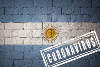 Flag of the Argentina with original proportions. stamped of Coronavirus. brick wall texture. Corona virus concept. On the verge of a COVID-19 or 2019-nCoV Pandemic.