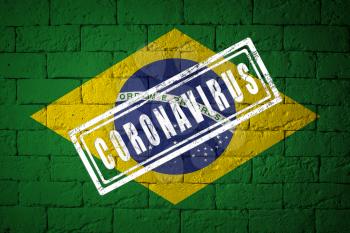 Flag of the Brazil with original proportions. stamped of Coronavirus. brick wall texture. Corona virus concept. On the verge of a COVID-19 or 2019-nCoV Pandemic.