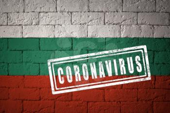 Flag of the Bulgaria with original proportions. stamped of Coronavirus. brick wall texture. Corona virus concept. On the verge of a COVID-19 or 2019-nCoV Pandemic.