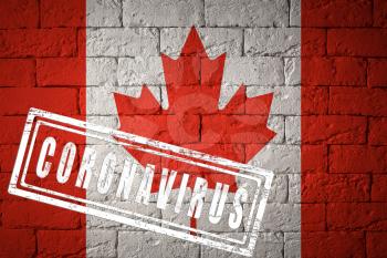 Flag of the Canada with original proportions. stamped of Coronavirus. brick wall texture. Corona virus concept. On the verge of a COVID-19 or 2019-nCoV Pandemic.