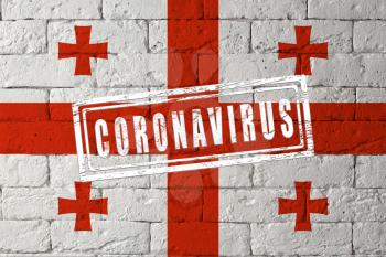 Flag of the Georgia with original proportions. stamped of Coronavirus. brick wall texture. Corona virus concept. On the verge of a COVID-19 or 2019-nCoV Pandemic.