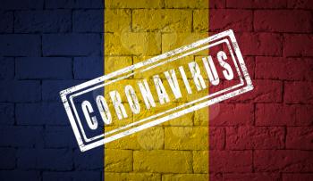 Flag of the Chad on brick wall texture. stamped of Coronavirus. Corona virus concept. On the verge of a COVID-19 or 2019-nCoV Pandemic. Novel Chinese Coronavirus outbreak