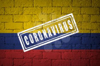 Flag of the Colombia with original proportions. stamped of Coronavirus. brick wall texture. Corona virus concept. On the verge of a COVID-19 or 2019-nCoV Pandemic.