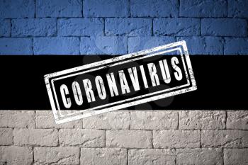Flag of the Estonia with original proportions. stamped of Coronavirus. brick wall texture. Corona virus concept. On the verge of a COVID-19 or 2019-nCoV Pandemic.