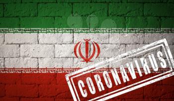 Flag of the Iran with original proportions. stamped of Coronavirus. brick wall texture. Corona virus concept. On the verge of a COVID-19 or 2019-nCoV Pandemic.