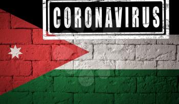 Flag of the Jordan with original proportions. stamped of Coronavirus. brick wall texture. Corona virus concept. On the verge of a COVID-19 or 2019-nCoV Pandemic.