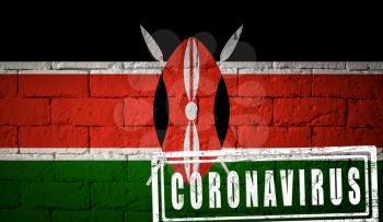 Flag of the Kenya on brick wall texture. stamped of Coronavirus. Corona virus concept. On the verge of a COVID-19 or 2019-nCoV Pandemic. Novel Chinese Coronavirus outbreak