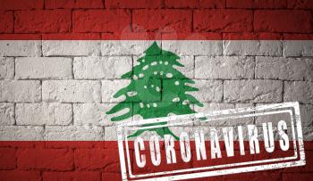 Flag of the Lebanon with original proportions. stamped of Coronavirus. brick wall texture. Corona virus concept. On the verge of a COVID-19 or 2019-nCoV Pandemic.