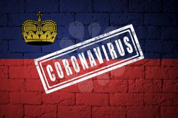 Flag of the Liechtenstein with original proportions. stamped of Coronavirus. brick wall texture. Corona virus concept. On the verge of a COVID-19 or 2019-nCoV Pandemic.