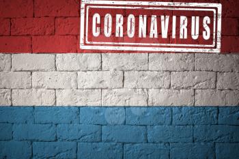 Flag of the Luxembourg with original proportions. stamped of Coronavirus. brick wall texture. Corona virus concept. On the verge of a COVID-19 or 2019-nCoV Pandemic.