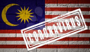 Flag of the Malaysia with original proportions. stamped of Coronavirus. brick wall texture. Corona virus concept. On the verge of a COVID-19 or 2019-nCoV Pandemic.
