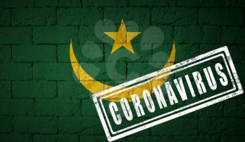 Flag of the Mauritania on brick wall texture. stamped of Coronavirus. Corona virus concept. On the verge of a COVID-19 or 2019-nCoV Pandemic. Novel Chinese Coronavirus outbreak