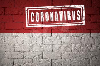 Flag of the Monaco with original proportions. stamped of Coronavirus. brick wall texture. Corona virus concept. On the verge of a COVID-19 or 2019-nCoV Pandemic.
