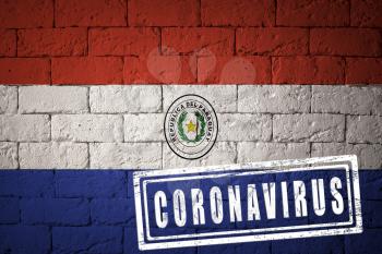 Flag of the Paraguay with original proportions. stamped of Coronavirus. brick wall texture. Corona virus concept. On the verge of a COVID-19 or 2019-nCoV Pandemic.