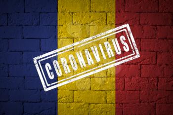 Flag of the Romania with original proportions. stamped of Coronavirus. brick wall texture. Corona virus concept. On the verge of a COVID-19 or 2019-nCoV Pandemic.