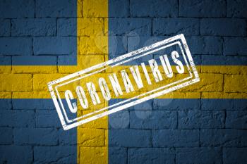Flag of the Sweden with original proportions. stamped of Coronavirus. brick wall texture. Corona virus concept. On the verge of a COVID-19 or 2019-nCoV Pandemic.