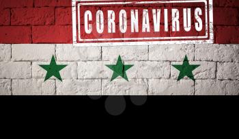 Flag of the Syria with original proportions. stamped of Coronavirus. brick wall texture. Corona virus concept. On the verge of a COVID-19 or 2019-nCoV Pandemic.