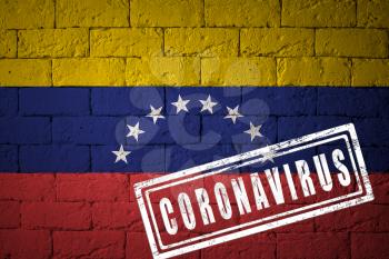 Flag of the Venezuela with original proportions. stamped of Coronavirus. brick wall texture. Corona virus concept. On the verge of a COVID-19 or 2019-nCoV Pandemic.