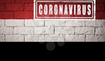 Flag of the Yemen with original proportions. stamped of Coronavirus. brick wall texture. Corona virus concept. On the verge of a COVID-19 or 2019-nCoV Pandemic.