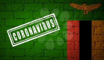 Flag of the Zambia on brick wall texture. stamped of Coronavirus. Corona virus concept. On the verge of a COVID-19 or 2019-nCoV Pandemic. Novel Chinese Coronavirus outbreak