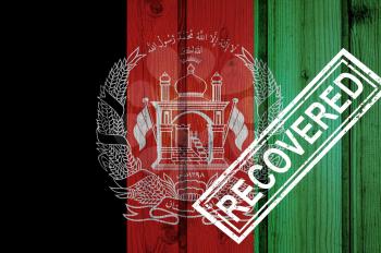 flag of Afghanistan that survived or recovered from the infections of corona virus epidemic or coronavirus. Grunge flag with stamp Recovered