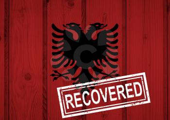 flag of Albania that survived or recovered from the infections of corona virus epidemic or coronavirus. Grunge flag with stamp Recovered