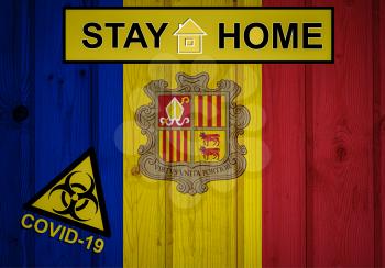 Flag of the Andorrain original proportions. Quarantine and isolation - Stay at home. flag with biohazard symbol and inscription COVID-19.