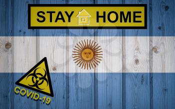 Flag of the Argentina in original proportions. Quarantine and isolation - Stay at home. flag with biohazard symbol and inscription COVID-19.