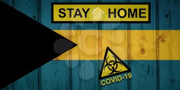 Flag of the Bahamas in original proportions. Quarantine and isolation - Stay at home. flag with biohazard symbol and inscription COVID-19.