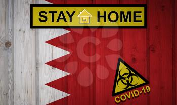 Flag of the Bahrain in original proportions. Quarantine and isolation - Stay at home. flag with biohazard symbol and inscription COVID-19.