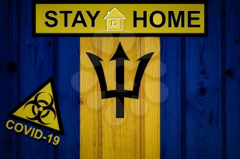 Flag of the Barbados in original proportions. Quarantine and isolation - Stay at home. flag with biohazard symbol and inscription COVID-19.