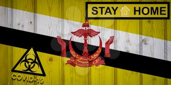 Flag of the Brunei in original proportions. Quarantine and isolation - Stay at home. flag with biohazard symbol and inscription COVID-19.