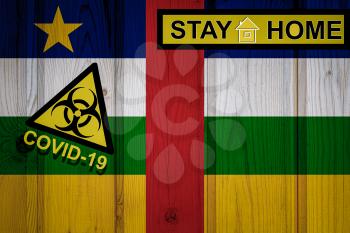 Flag of the Central African Republic in original proportions. Quarantine and isolation - Stay at home. flag with biohazard symbol and inscription COVID-19.