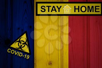 Flag of the Chad in original proportions. Quarantine and isolation - Stay at home. flag with biohazard symbol and inscription COVID-19.