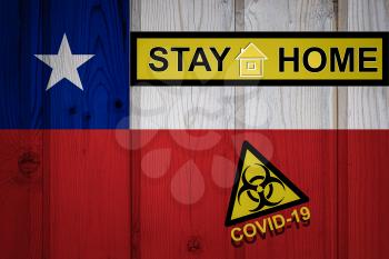 Flag of the Chile in original proportions. Quarantine and isolation - Stay at home. flag with biohazard symbol and inscription COVID-19.