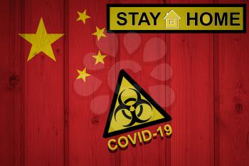 Flag of the China in original proportions. Quarantine and isolation - Stay at home. flag with biohazard symbol and inscription COVID-19.