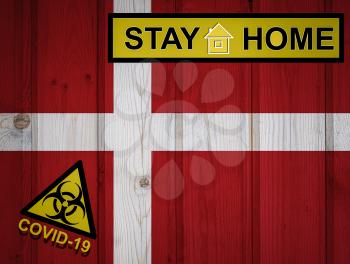 Flag of the Denmark in original proportions. Quarantine and isolation - Stay at home. flag with biohazard symbol and inscription COVID-19.