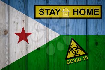 Flag of the Djibouti in original proportions. Quarantine and isolation - Stay at home. flag with biohazard symbol and inscription COVID-19.