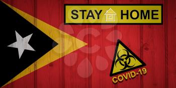 Flag of the East Timorin in original proportions. Quarantine and isolation - Stay at home. flag with biohazard symbol and inscription COVID-19.