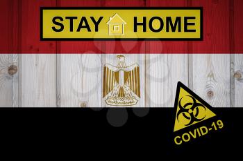 Flag of the Egypt in original proportions. Quarantine and isolation - Stay at home. flag with biohazard symbol and inscription COVID-19.