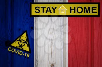 Flag of the France in original proportions. Quarantine and isolation - Stay at home. flag with biohazard symbol and inscription COVID-19.