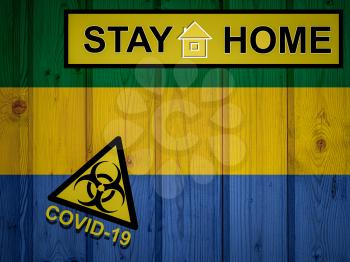 Flag of the Gabon in original proportions. Quarantine and isolation - Stay at home. flag with biohazard symbol and inscription COVID-19.