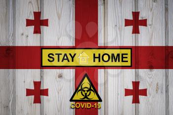 Flag of the Georgia in original proportions. Quarantine and isolation - Stay at home. flag with biohazard symbol and inscription COVID-19.