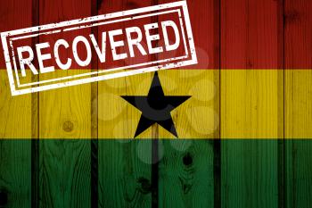 flag of Ghana that survived or recovered from the infections of corona virus epidemic or coronavirus. Grunge flag with stamp Recovered