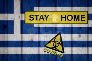 Flag of the Greece in original proportions. Quarantine and isolation - Stay at home. flag with biohazard symbol and inscription COVID-19.